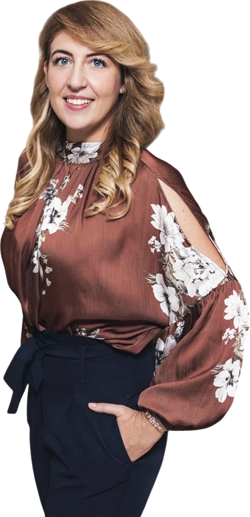 Dr. Monica Perna standing, smiling, in a floral blouse